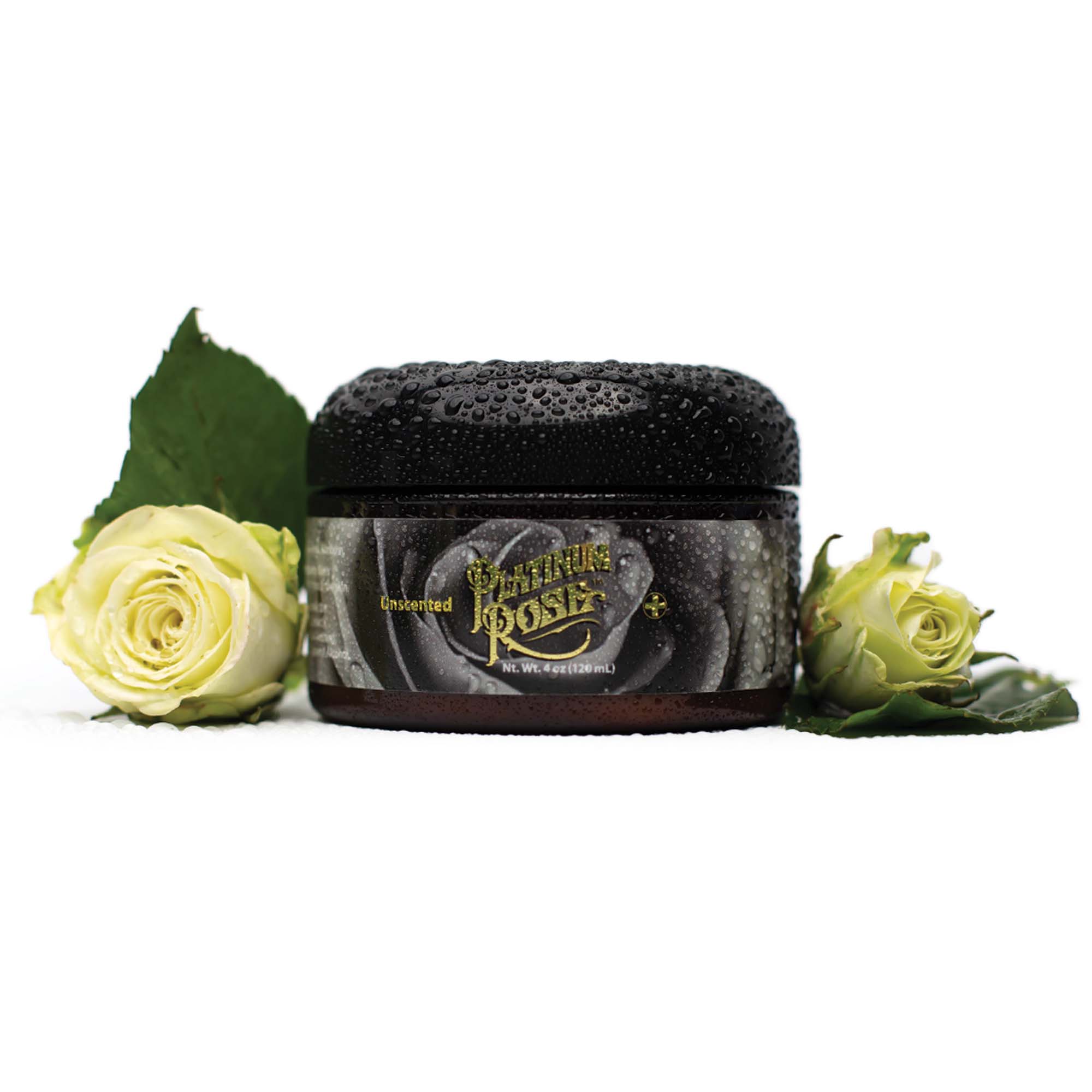 A 4oz Jar of unscented Platinum Rose tattoo Aftercare Surrounded by Freshly Cut White Roses